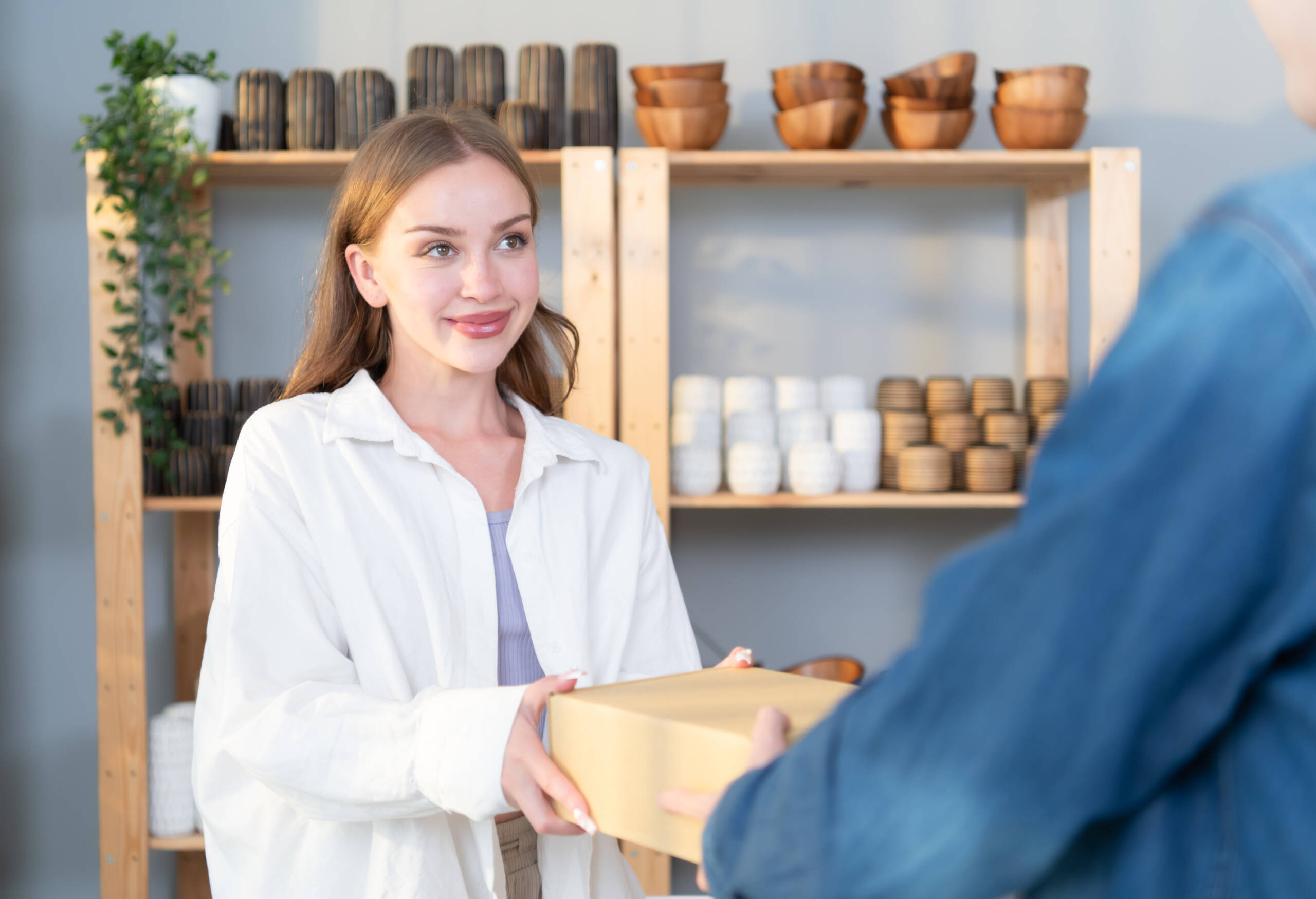 A young couple runs a small business making clay jewelry. They support one another as they work toward becoming larger business in the future.